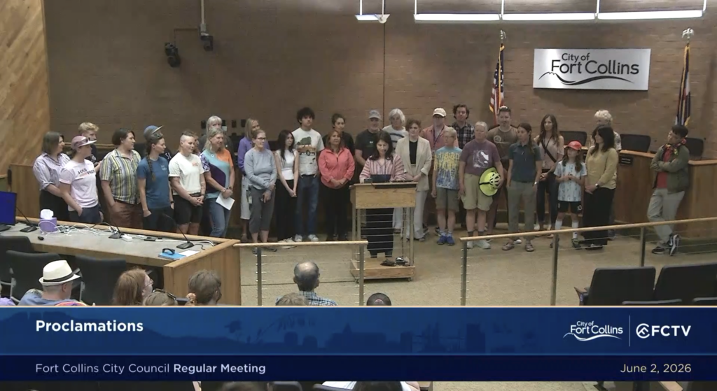 Community members gather in support of the city's bike month proclamation. 
